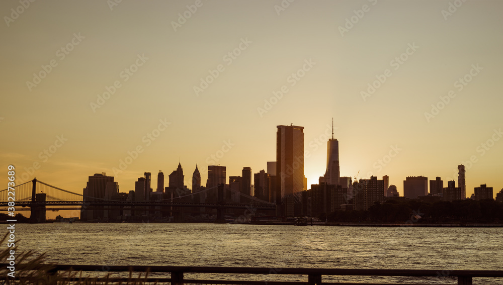View of a Manhattan sunset from the Brooklyn Side (Domino Park) View of a Manhattan sunset from the Brooklyn Side (Domino Park)