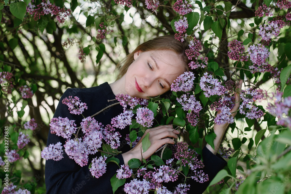 Portrait of a woman with lilac in blossom Portrait of a woman with lilac in blossom