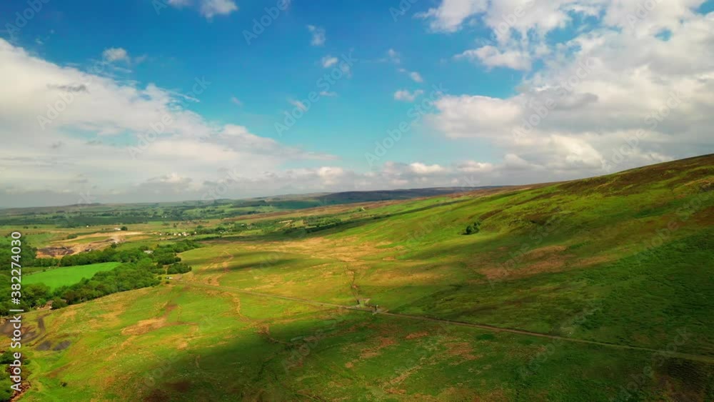 Aerial landscape showing the sloping hills of the english lake district, bright blue sky day. Aerial landscape showing the sloping hills of the english lake district, bright blue sky day.