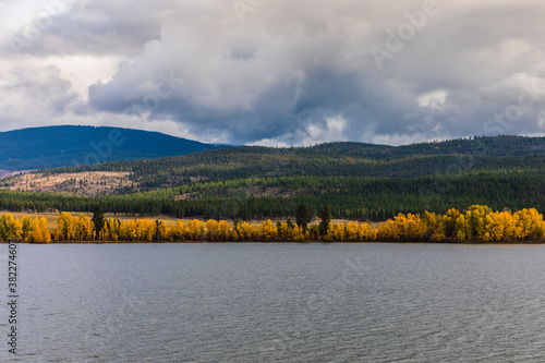 A lake and mountain view with trees changing color for the fall photo