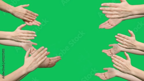 Hands are clapping on green screen background. Female hands silhouette clapping on a chroma key background photo