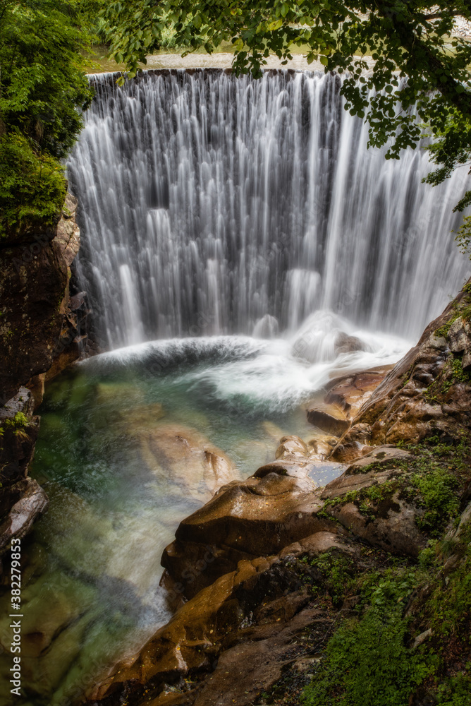 Fototapeta premium Beautiful man-made waterfall with a pool.