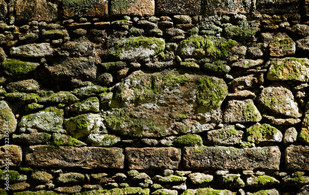 Ancient stone wall with moss background, Brazil 