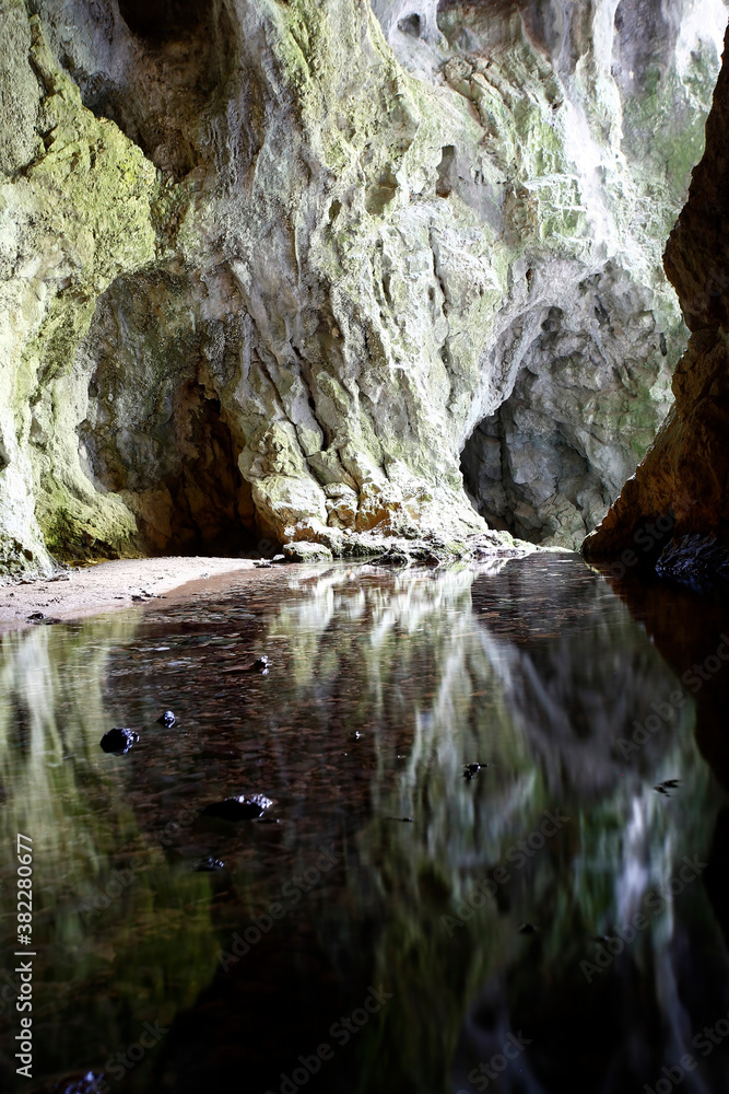 Reflection of rocks in the water in the cave