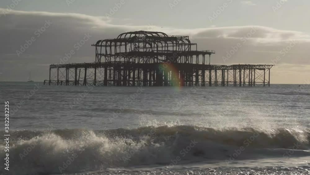 zoom out view of famous burnt pier in brighton city england uk. small waves breaking on the beach zoom out view of famous burnt pier in brighton city england uk. small waves breaking on the beach