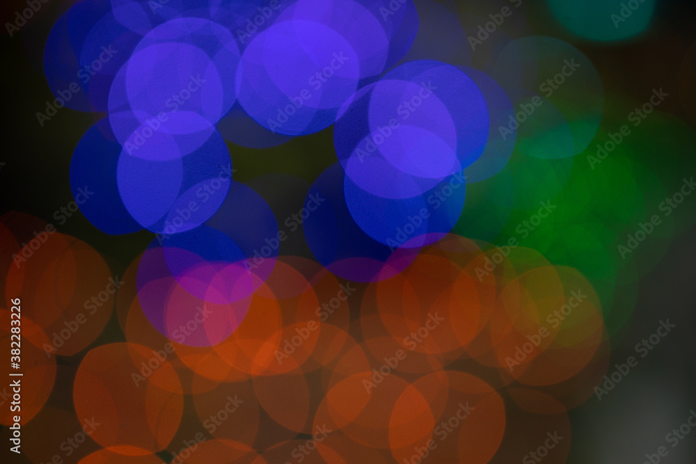 Round balls of light in red, blue and green against dark background Round balls of light in red, blue and green against dark background