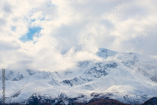panoramic view of picturesque snowy mountains tops on blue sky background
