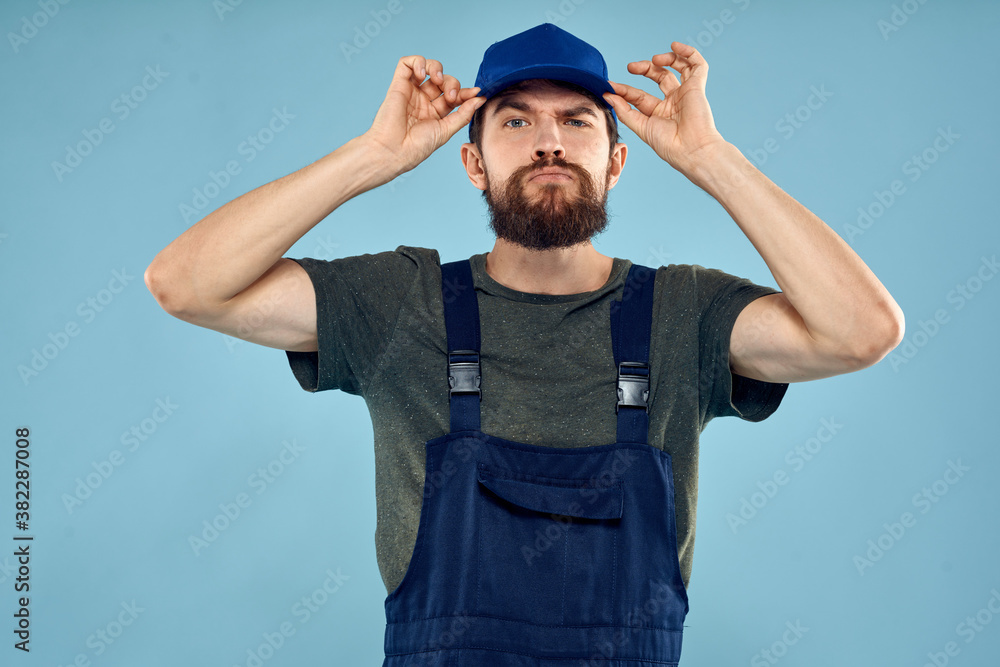 man in work uniform uniform professional work lifestyle delivery service blue background