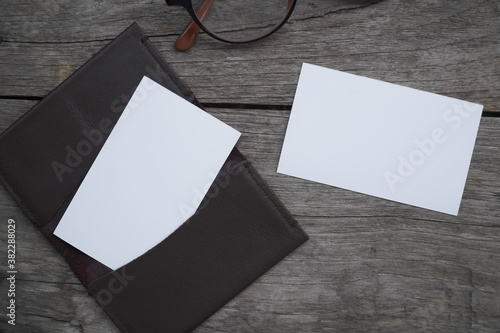 Business card mock up with card holder on old wooden table background