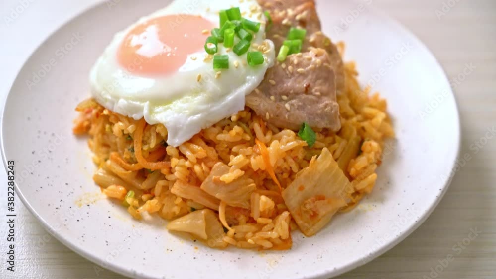 Kimchi fried rice with fried egg and pork - Korean food style Kimchi fried rice with fried egg and pork - Korean food style