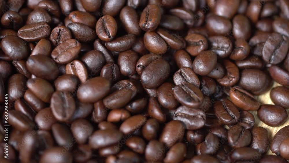 Coffee beans are falling, slow motion. Coffee beans rotation close-up. Coffee beans are falling, slow motion. Coffee beans rotation close-up.