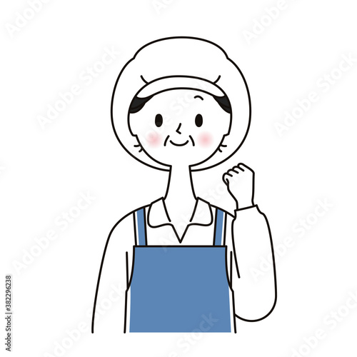 作業服 ガッツポーズをする調理補助のシニア女性