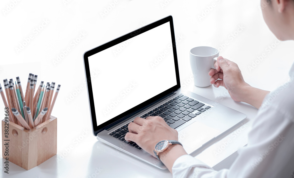 Closeup view of man hands working with laptop computer and holding mug while sitting at office desk. Closeup view of man hands working with laptop computer and holding mug while sitting at office desk.