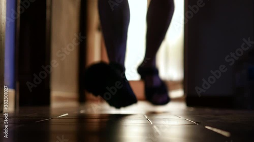 Unfocused scene showing a man running to help someone who has fallen to the ground at home