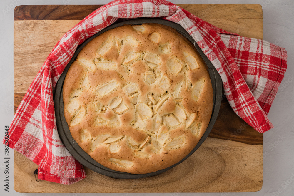 Apple cake with sliced apples on baking pan, just from oven, close up view from above Apple cake with sliced apples on baking pan, just from oven, close up view from above