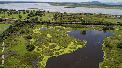Aerial view panorama of Magdalena River landscape with straight road on a sunny day 