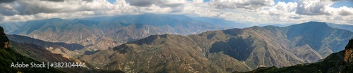 Impressive panorama of mountains and Chicamocha canyon with white clouds from Monument of the Virgin Mary at Chicamocha National Park, Colombia