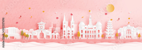 Autumn in Ho Chi Minh City, Vietnam with falling leaves and world famous landmarks in paper cut style vector illustration