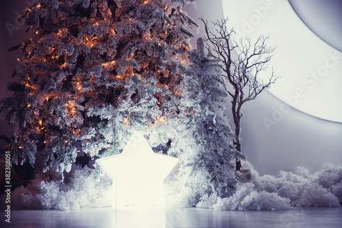 Mystical nighttime New Year decorations, falling star under Christmas tree with snow