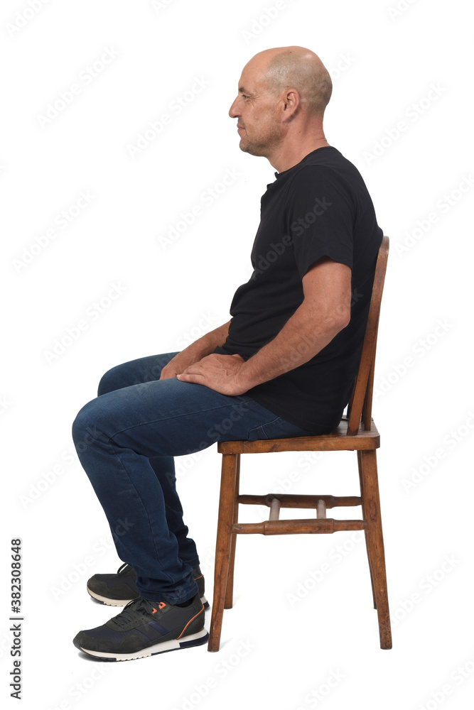 full portrait of a bald man sitting sideways on white background, full portrait of a bald man sitting sideways on white background,
