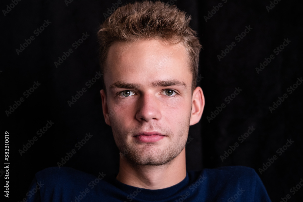 Portrait of a serious handsome young guy on a dark background Portrait of a serious handsome young guy on a dark background