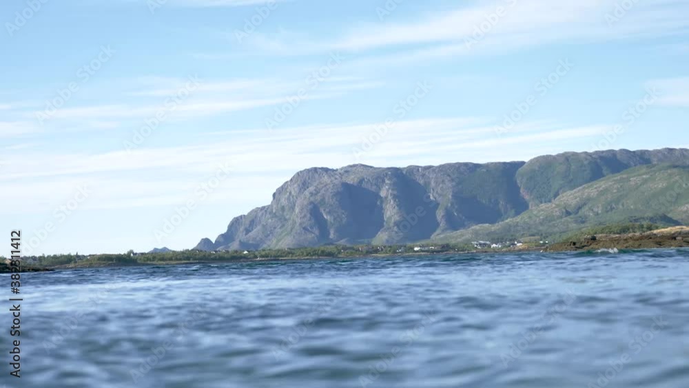 Great mountain with ocean moving in foreground in Northern Norway Great mountain with ocean moving in foreground in Northern Norway