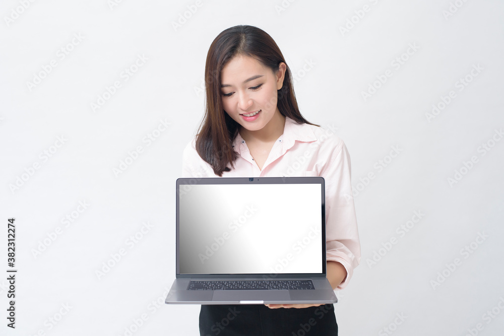 An asian woman is holding laptop computer on white Studio background An asian woman is holding laptop computer on white Studio background