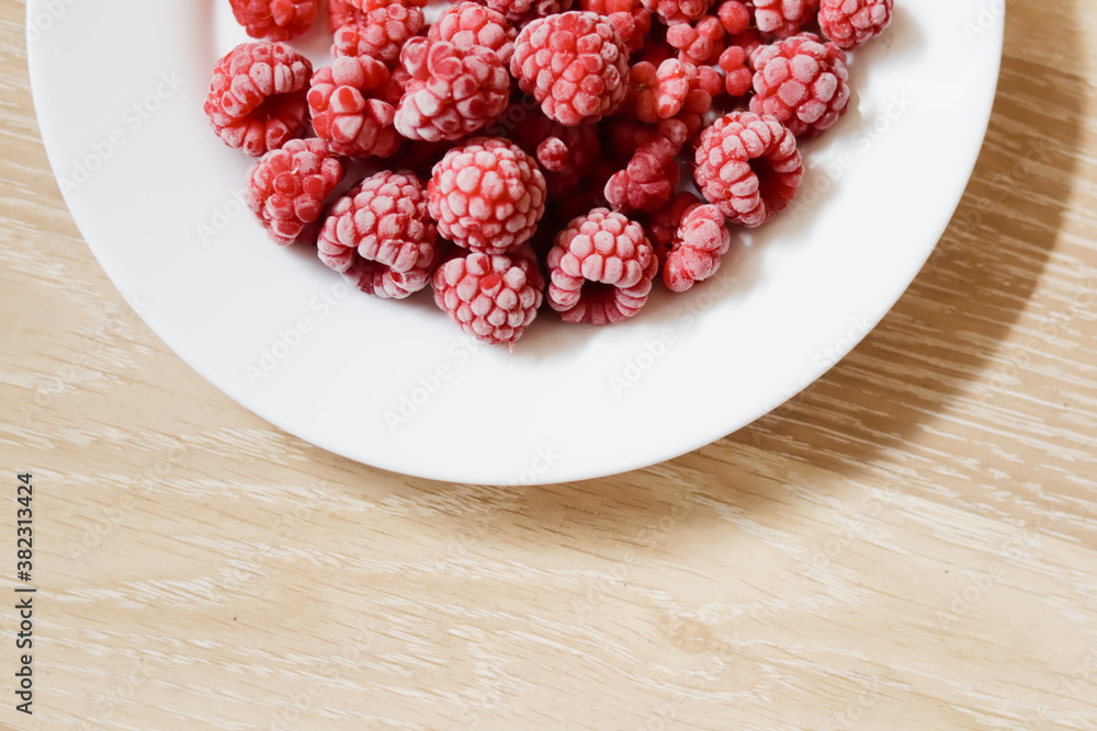 Raspberry on the plate. Sweet fruit.