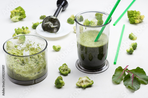 Mugs with green vegetable smoothies