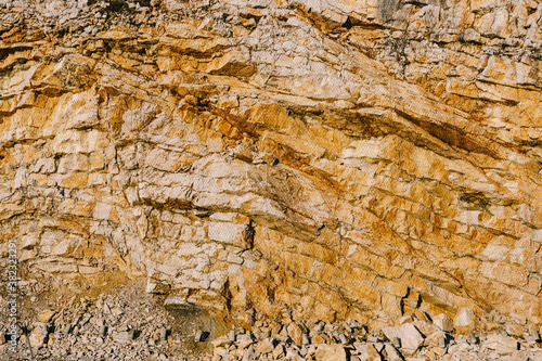 Layered stones near the road are tightened with a metal mesh netting to protect against landslides.