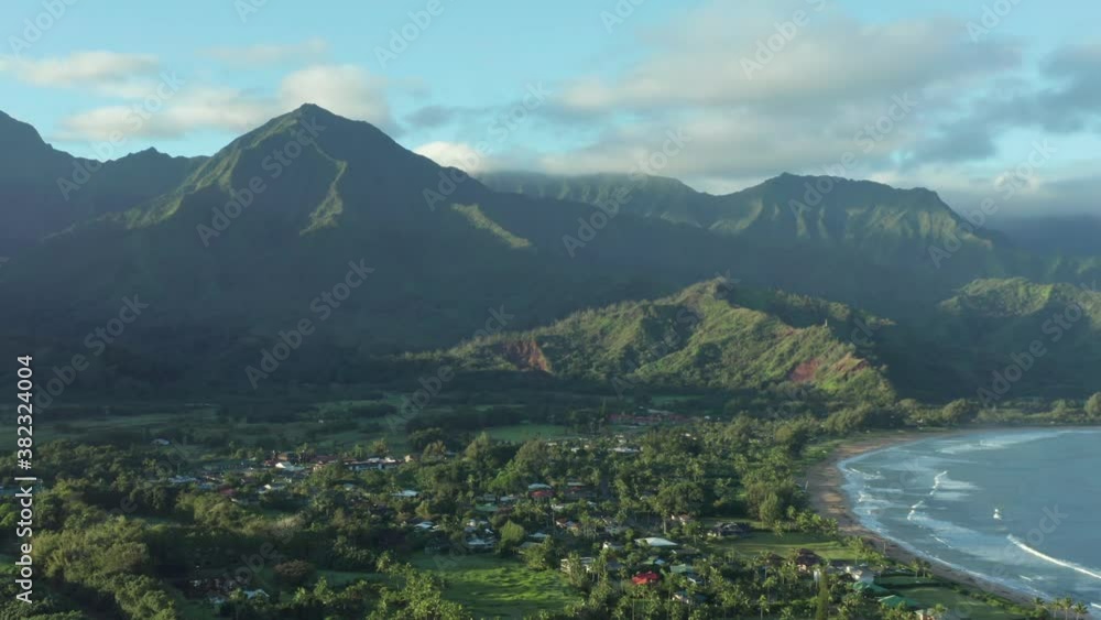Kauai Hanalei Bay 4k aerial drone shot. View of town village by the ocean between palm trees. Vacation dream in tropical environment. Overview on beautiful sunny morning in Hawaii Kauai Hanalei Bay 4k aerial drone shot. View of town village by the ocean between palm trees. Vacation dream in tropical environment. Overview on beautiful sunny morning in Hawaii
