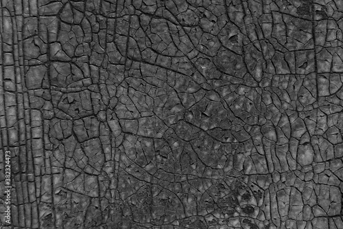 Dark cracked texture background. Old sheet of rubber.