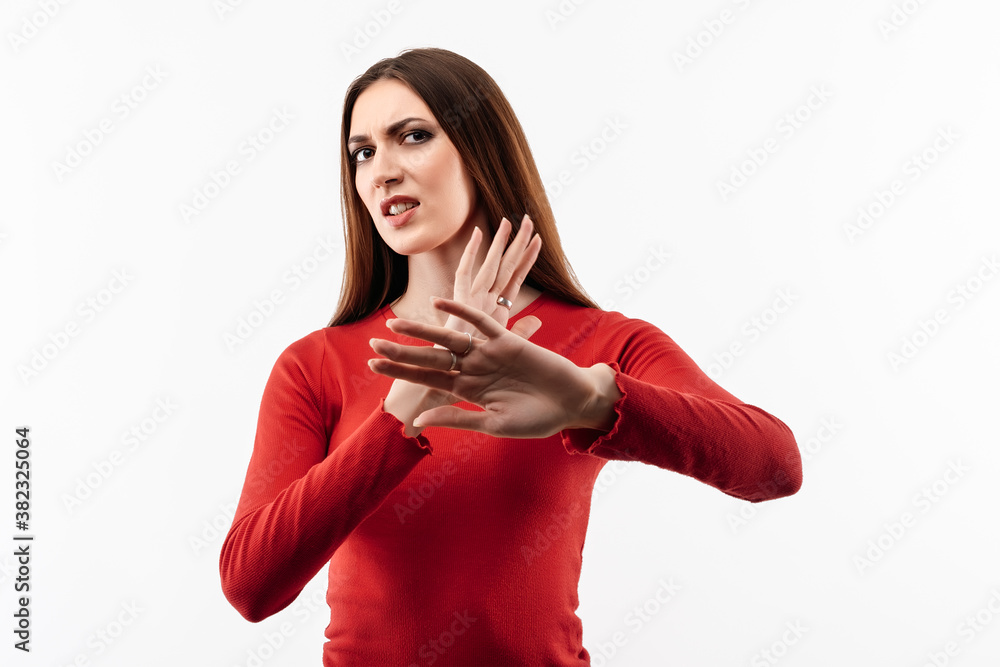 Naklejka premium Image of dissatisfied girl doing disgust face because aversion reaction with hands raised. Facial expression concept