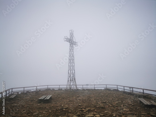 Cross at the top of Tarnica Bieszczady. Autumn in the Bieszczady Mountains Poland. Mountain trails in the Bieszczady Mountains. Trekking in the Bieszczady Mountains.