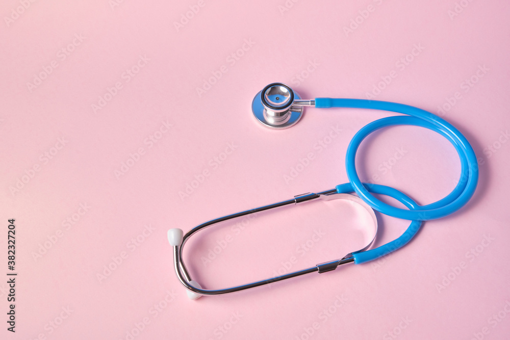blue stethoscope on pink background. For check heart or health check up concept blue stethoscope on pink background. For check heart or health check up concept