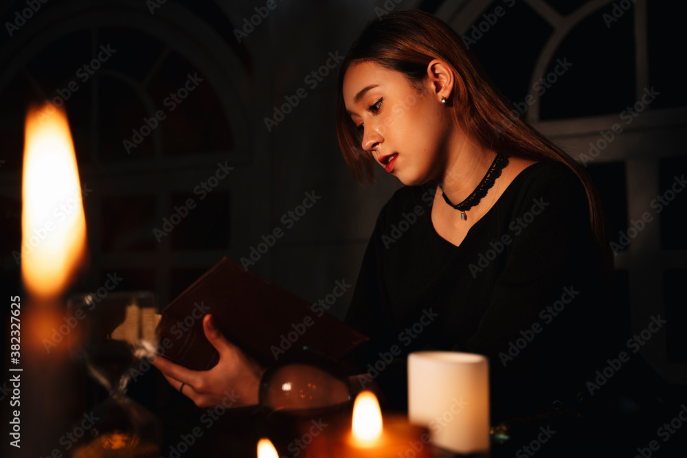 Naklejka premium Witch learning spell from magical book.