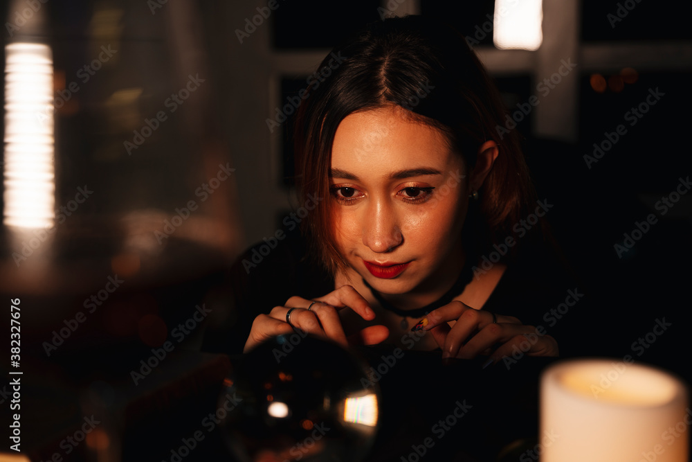 Beautiful young woman fortune teller predict the future with crystal ball. Beautiful young woman fortune teller predict the future with crystal ball.