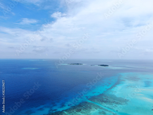 Blue Maldive islands seascape with cloudy sky