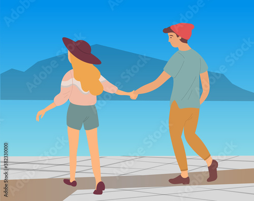 Couple walking in a city park. Young guy and girl holding hands walking in evening alley, romantic walk. Lovers man and woman met on a date outdoor. Romantic promenade in the open air active lifestyle