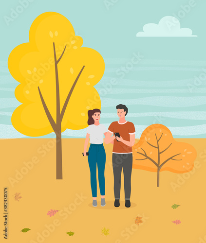 Couple walking in a park. Young guy and girl holding hands walking in autumn garden, romantic walk. Lovers man and woman met on a date outdoor. Romantic promenade in the open air, active lifestyle