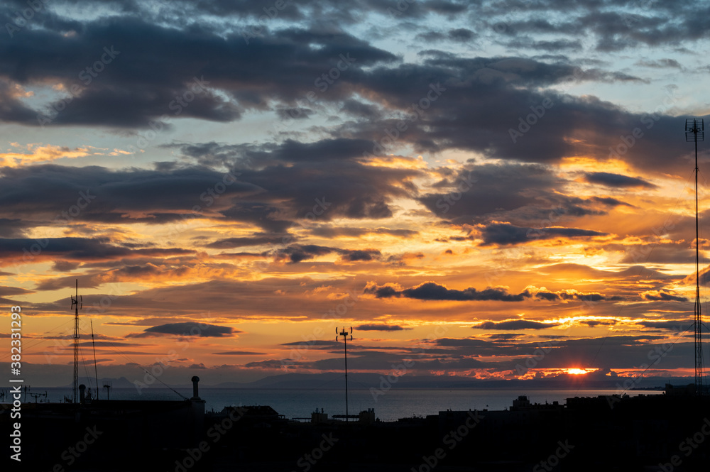 a golden blue sunset with a city silhouette overlooking the Mediterranean sea a golden blue sunset with a city silhouette overlooking the Mediterranean sea