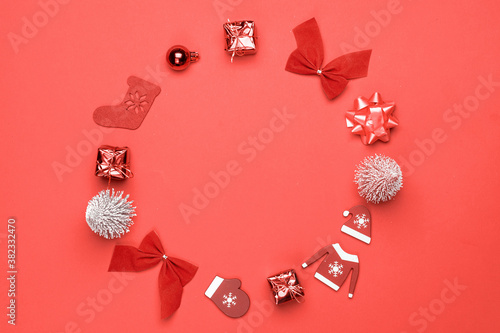 Xmas sale. Stocking, gifts, winter tree, ribbon and bow in shape frame on red background for greeting card. Winter festive composition with copy space.