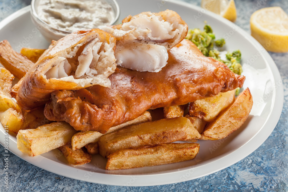 Fish in beer batter and chips with green pea and tartar sauce Fish in beer batter and chips with green pea and tartar sauce