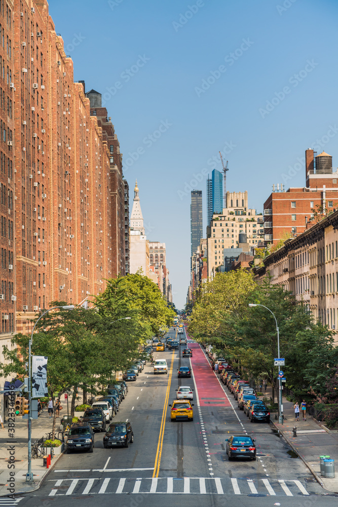 Fototapeta premium Manhattan street where you can see pedestrians and cars in an evening light