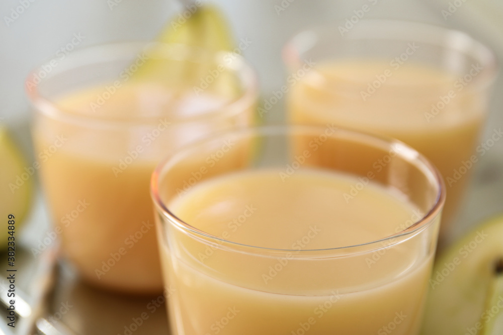 Glasses of tasty fresh pear juice, closeup Glasses of tasty fresh pear juice, closeup