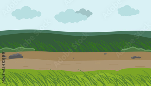 Windy weather at field, green grass bend down fom wind, ground road, clouds at sky background, bad conditions outdoors, day landscape, countryside, nobody around, environment with bending plants