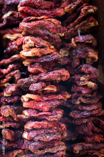 dried tomatoes hanging in clustersappetizer, background, closeup, clusters, cooking, dehydrator, detail, dry, dry-ed, food, green, handmade, hanging, healthy, heap, homemade, ingredient, isolated, ita