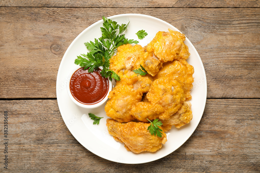 Tasty deep fried chicken pieces served on wooden table, top view Tasty deep fried chicken pieces served on wooden table, top view