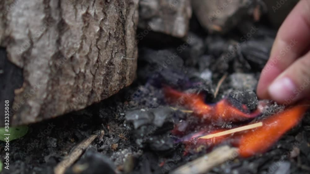 Light up ignite inflame campfire with match. Bonfire Closeup of flames burning in slow motion Light up ignite inflame campfire with match. Bonfire Closeup of flames burning in slow motion