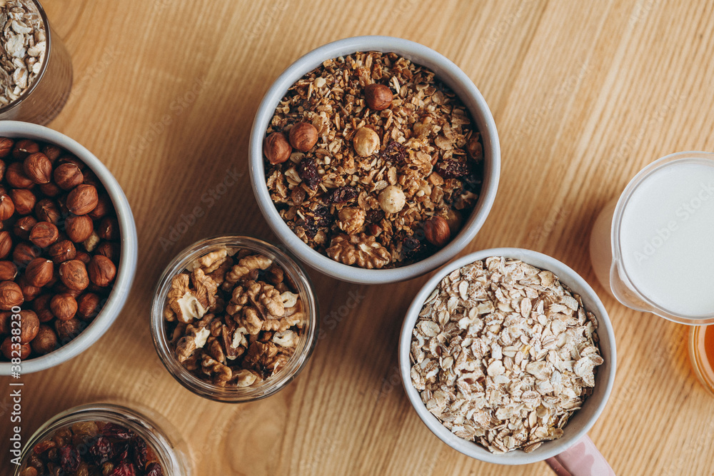 homemade granola for breakfast and the ingredients from which it is prepared, top view homemade granola for breakfast and the ingredients from which it is prepared, top view